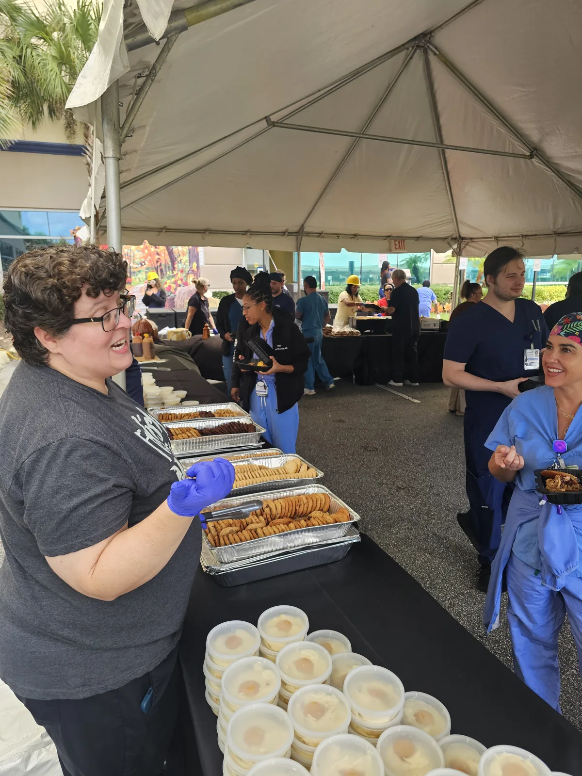 Guests and the catering team gathered around the dessert station