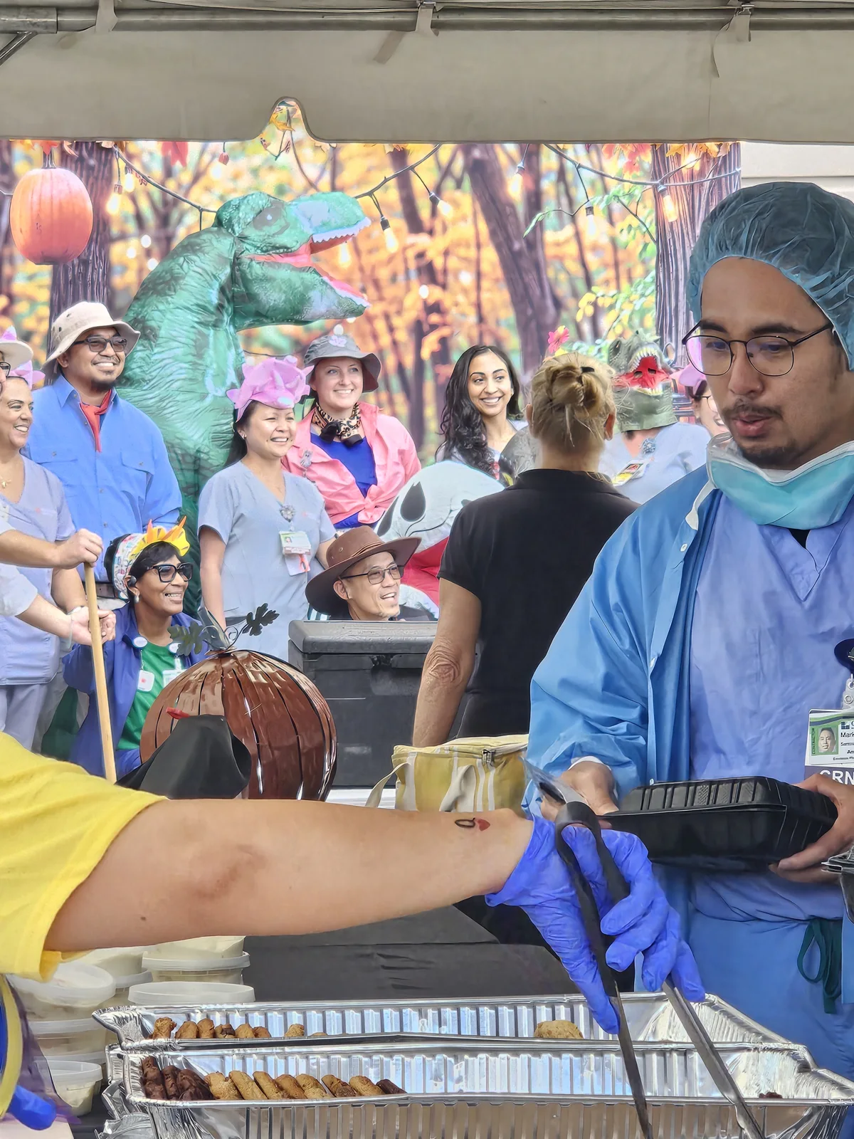 Hospital team members enjoying the Fall Festival while food is served
